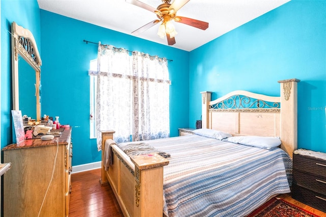 bedroom with ceiling fan and dark hardwood / wood-style flooring