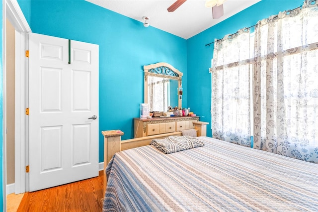 bedroom with ceiling fan and hardwood / wood-style floors