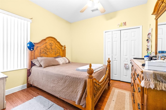 bedroom featuring ceiling fan, hardwood / wood-style floors, and a closet