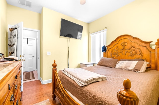 bedroom with ceiling fan and light wood-type flooring