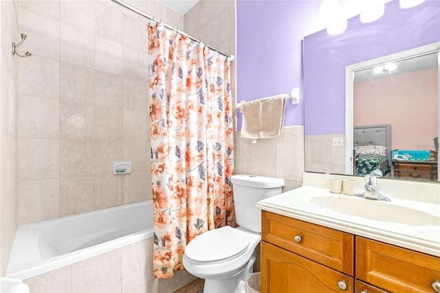 full bathroom featuring tile walls, vanity, shower / bath combination with curtain, and toilet