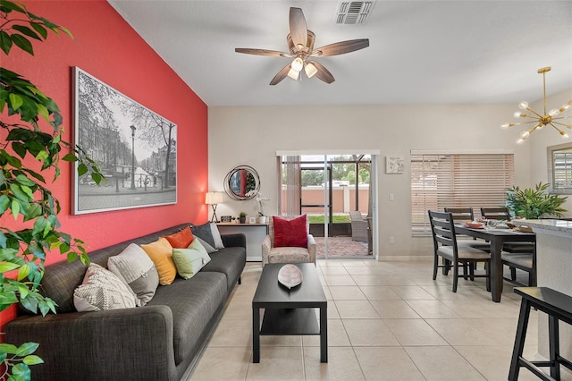 tiled living room featuring ceiling fan with notable chandelier