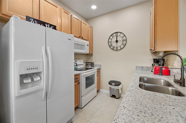 kitchen featuring light tile patterned floors, light stone counters, white appliances, and sink