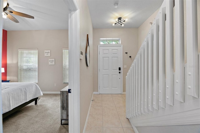 entrance foyer with ceiling fan, light tile patterned floors, and plenty of natural light