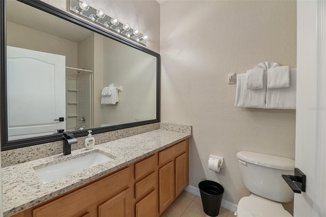 bathroom featuring toilet, tile patterned floors, and vanity