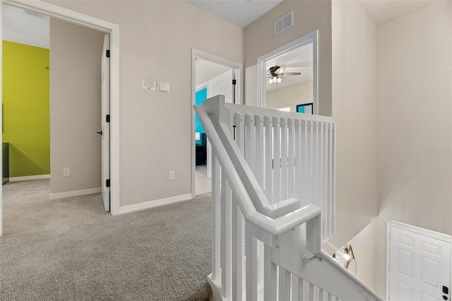 hallway featuring light colored carpet