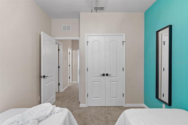 carpeted bedroom with a closet