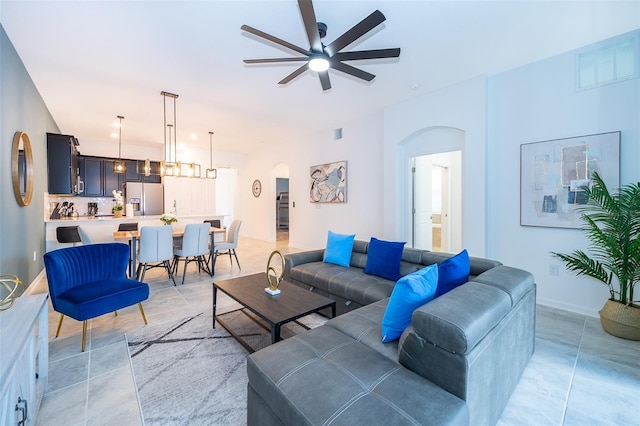 living room featuring light tile patterned flooring and ceiling fan