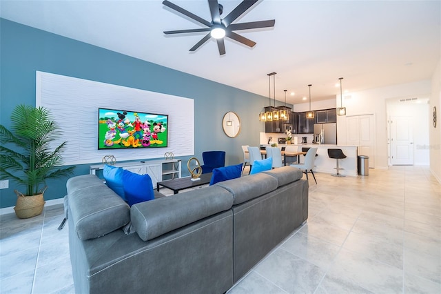 living room featuring ceiling fan and baseboards