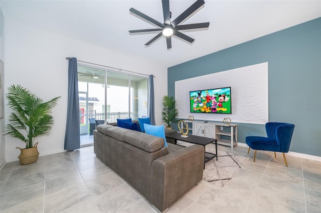 living room featuring ceiling fan and baseboards