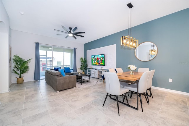 dining room with a ceiling fan and baseboards