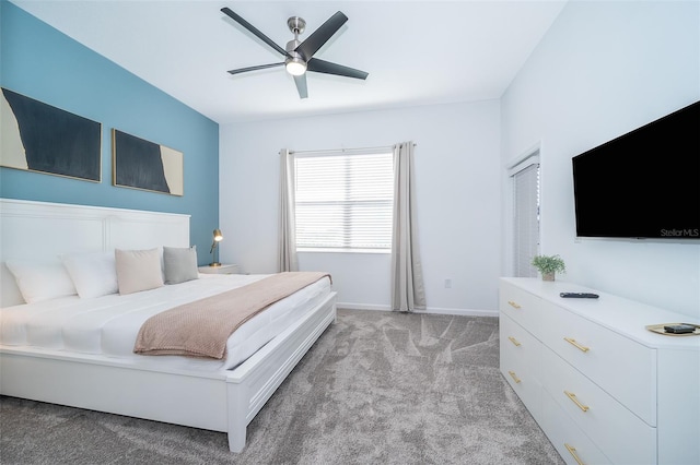 bedroom featuring baseboards, a ceiling fan, and light colored carpet