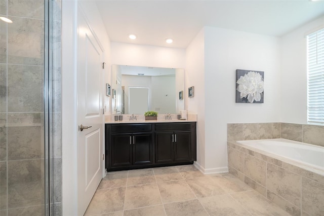 full bath with a garden tub, double vanity, tile patterned flooring, and a sink