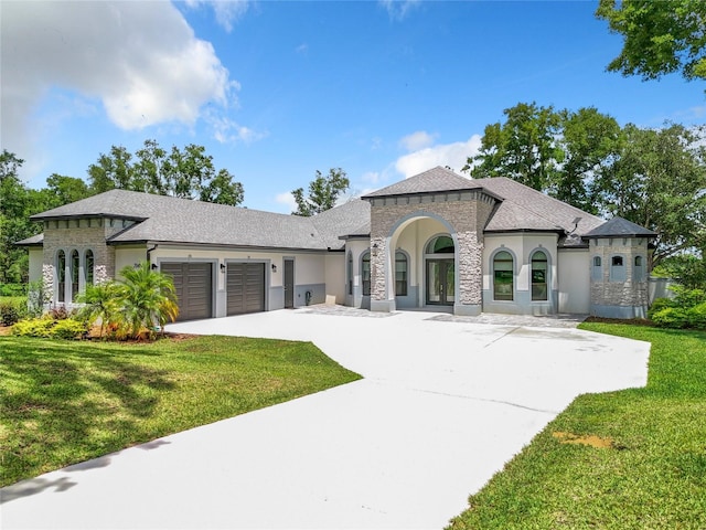 view of front of home featuring a garage and a front lawn