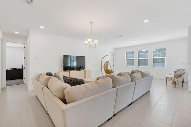 living room with a chandelier and light tile patterned floors