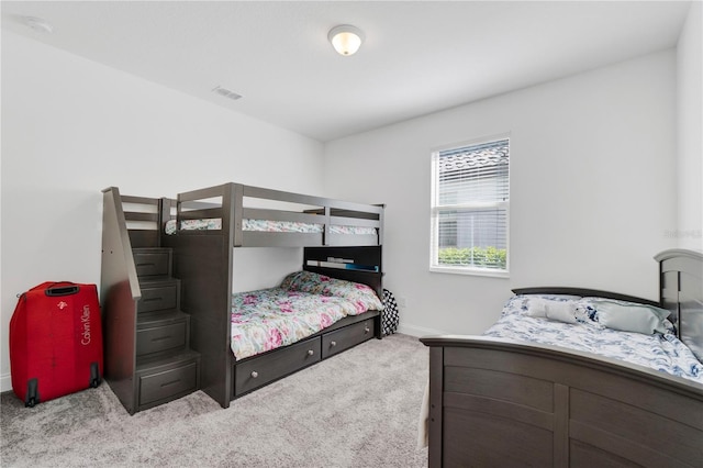 bedroom with light colored carpet