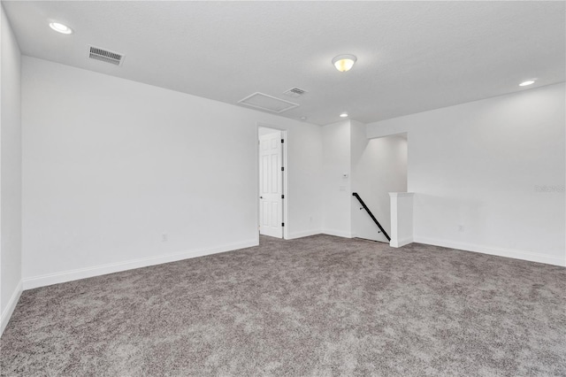 carpeted empty room featuring a textured ceiling