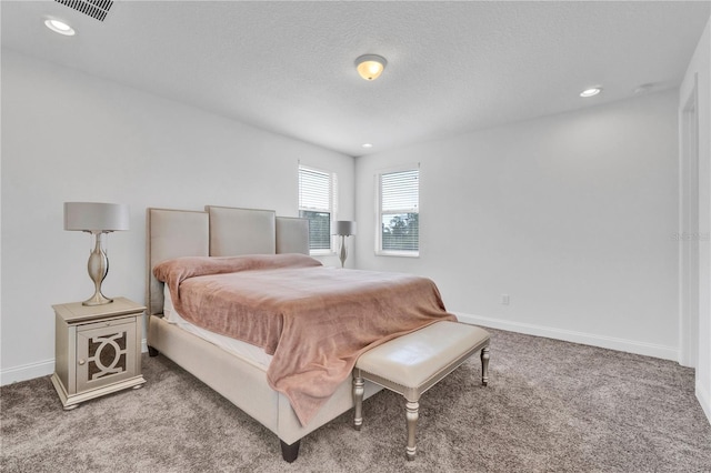 carpeted bedroom featuring a textured ceiling