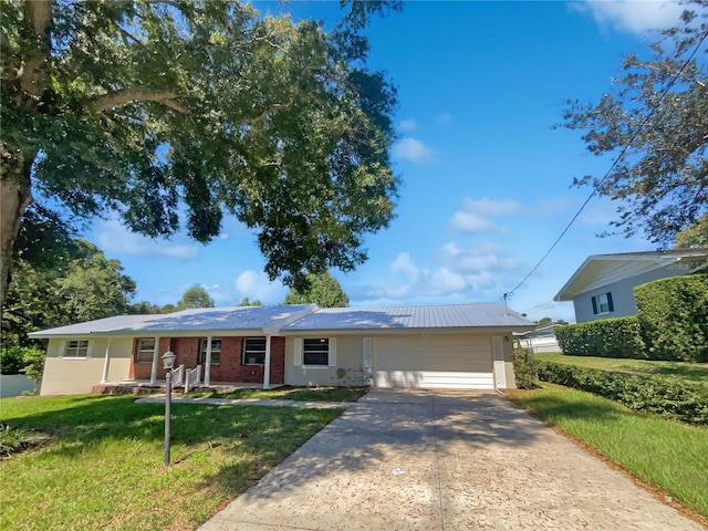 single story home featuring concrete driveway, brick siding, and a front lawn