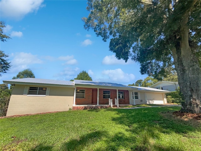 ranch-style home with a garage and a front yard