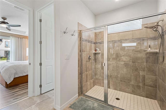 bathroom with ceiling fan, hardwood / wood-style flooring, and a shower with shower door