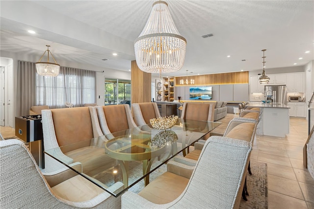 dining area with a chandelier and light tile patterned floors