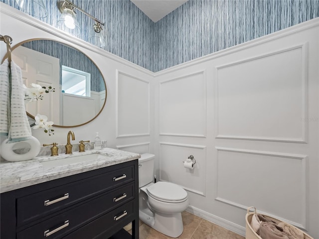 bathroom with tile patterned flooring, toilet, and vanity