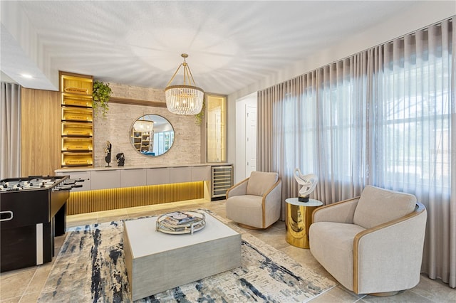 tiled living room featuring a notable chandelier