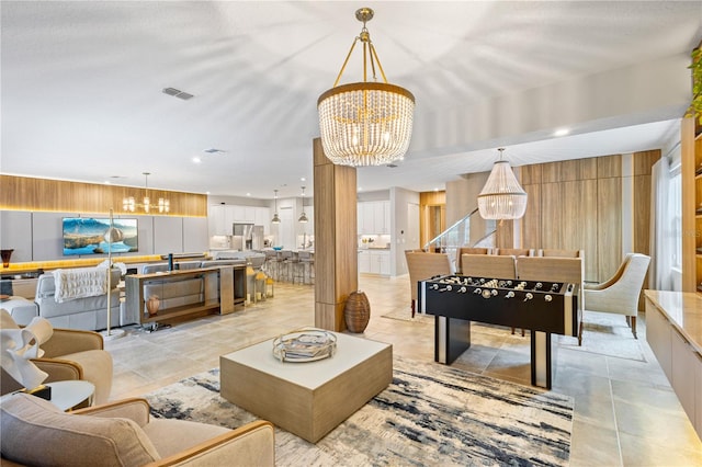 living room with a chandelier and light tile patterned floors