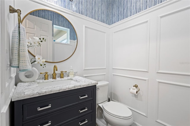 bathroom with toilet and vanity