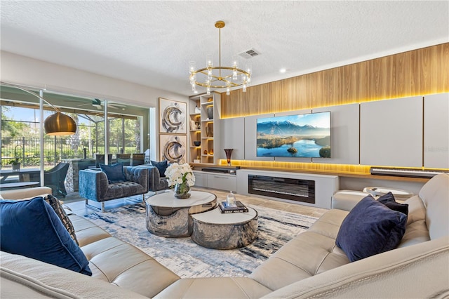 living room with a textured ceiling and a chandelier