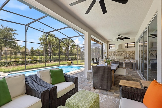 view of patio / terrace with glass enclosure, a fenced in pool, outdoor lounge area, an outdoor kitchen, and ceiling fan