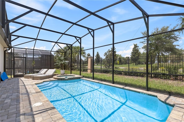 view of swimming pool featuring an in ground hot tub, glass enclosure, and a patio