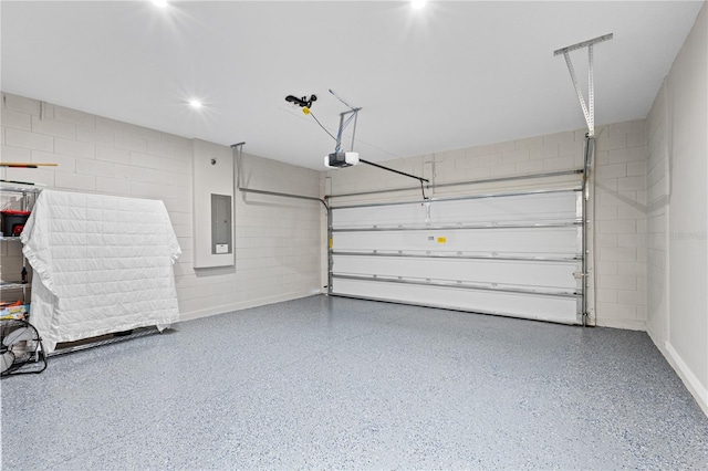 garage with a garage door opener and electric panel