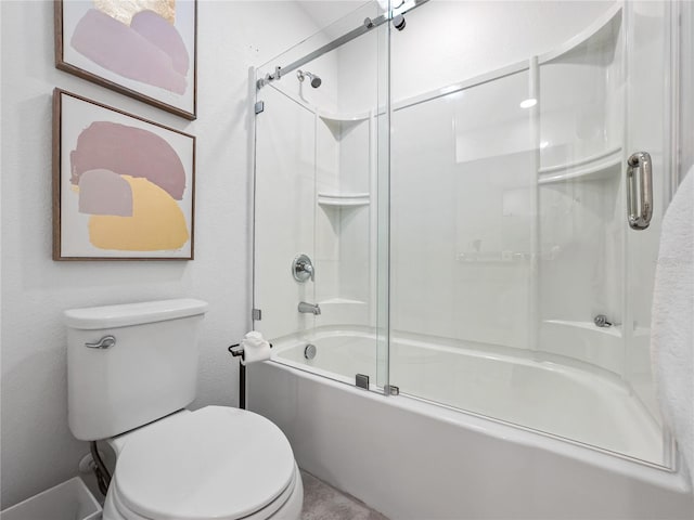 bathroom featuring combined bath / shower with glass door and toilet