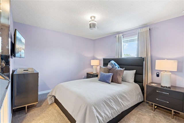 carpeted bedroom with a textured ceiling