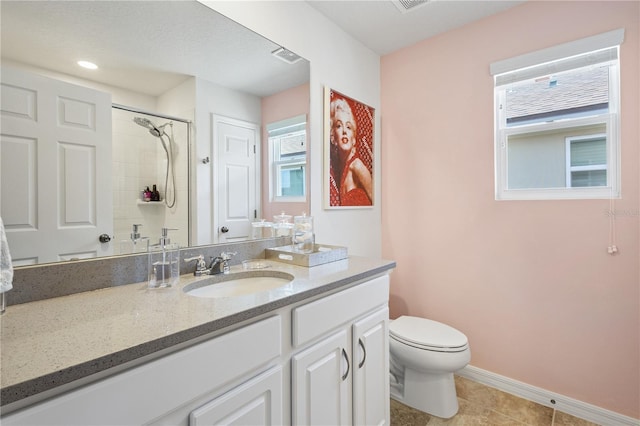 bathroom featuring tile patterned flooring, toilet, a textured ceiling, and vanity