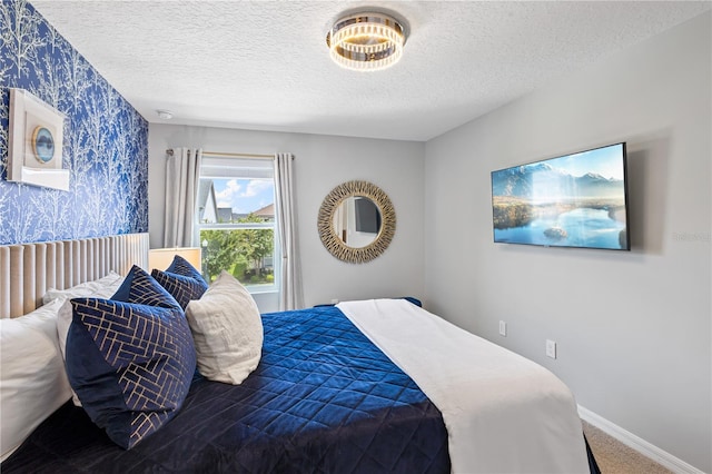 carpeted bedroom featuring a textured ceiling