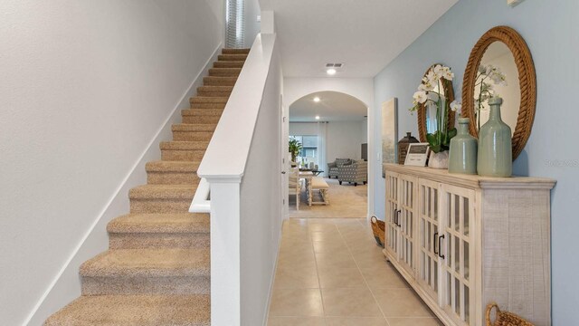 stairway featuring carpet flooring