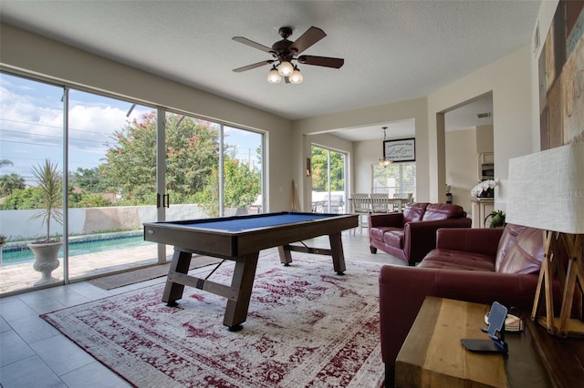 recreation room featuring tile patterned flooring, ceiling fan, billiards, and a textured ceiling