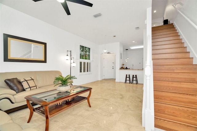 living room with ceiling fan and light tile patterned floors