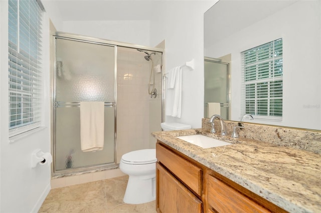 bathroom featuring tile patterned flooring, toilet, walk in shower, and vanity