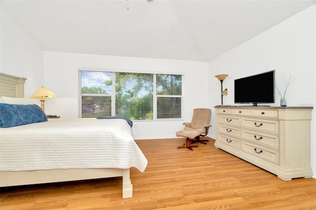 bedroom featuring vaulted ceiling and light hardwood / wood-style flooring