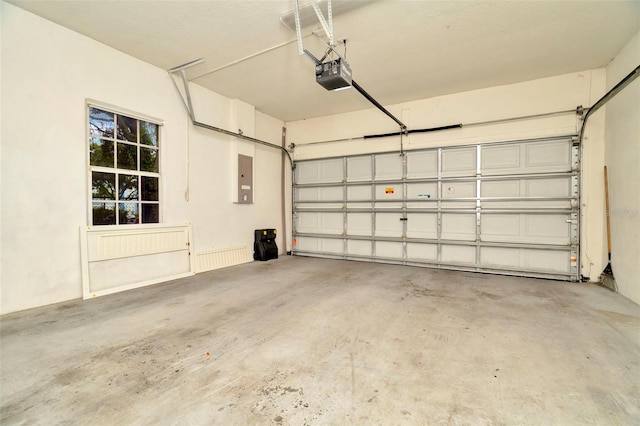 garage featuring a garage door opener and electric panel