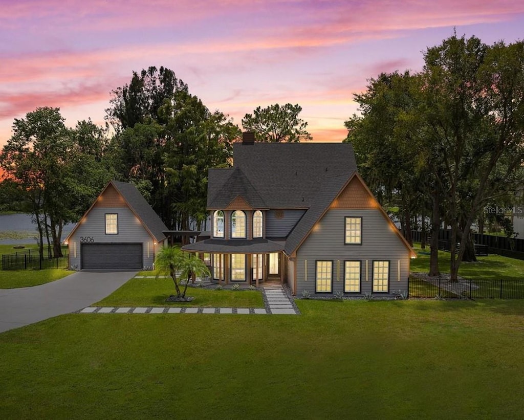 view of front of property featuring a yard, a chimney, an outdoor structure, and fence