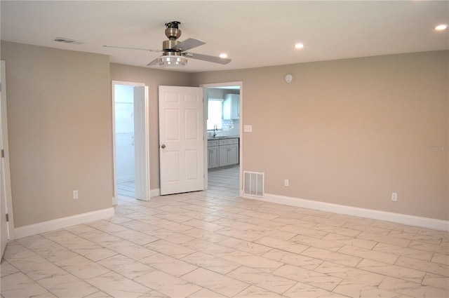 unfurnished room with sink and ceiling fan