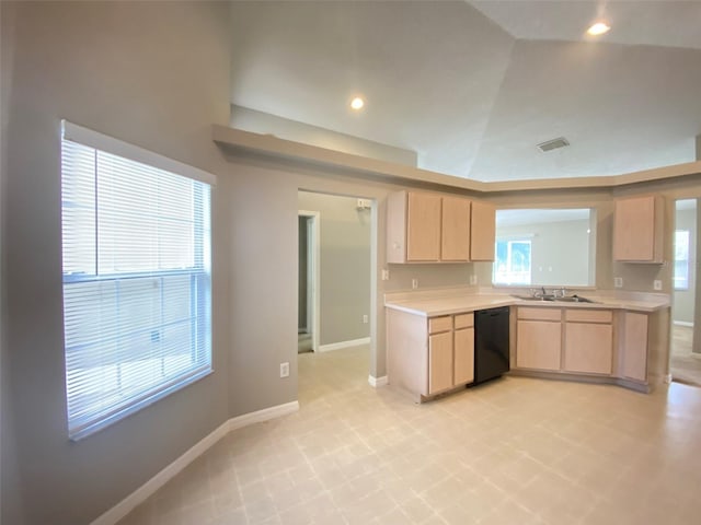 kitchen with a wealth of natural light, light tile patterned floors, dishwasher, and light brown cabinetry