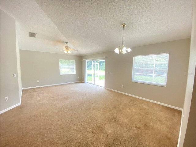 spare room featuring carpet flooring, a textured ceiling, and ceiling fan with notable chandelier