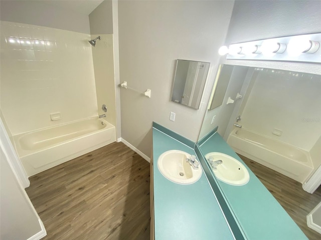 bathroom featuring bathtub / shower combination, vanity, and hardwood / wood-style flooring