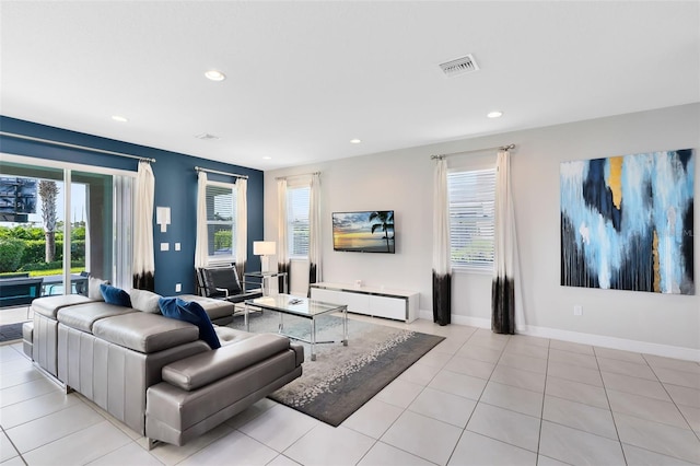 living room with light tile patterned floors, baseboards, visible vents, and recessed lighting